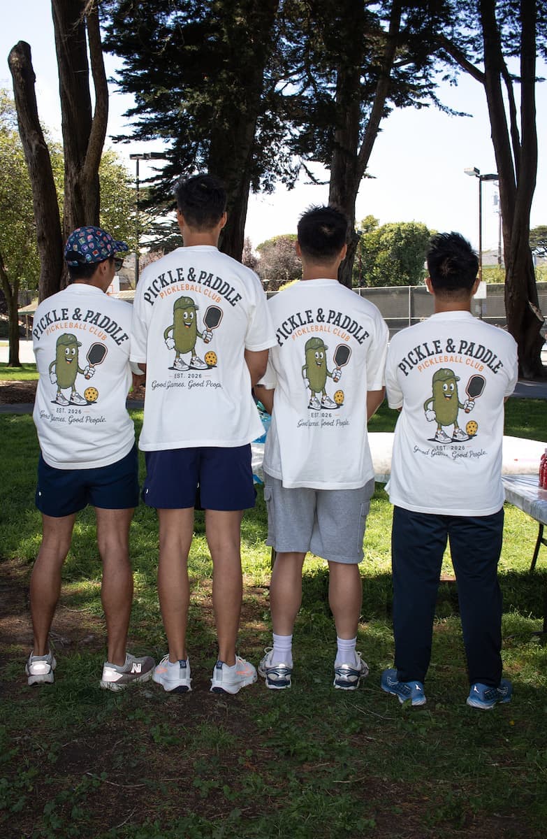 Members showing off the pickle mascot on the back of their club tees