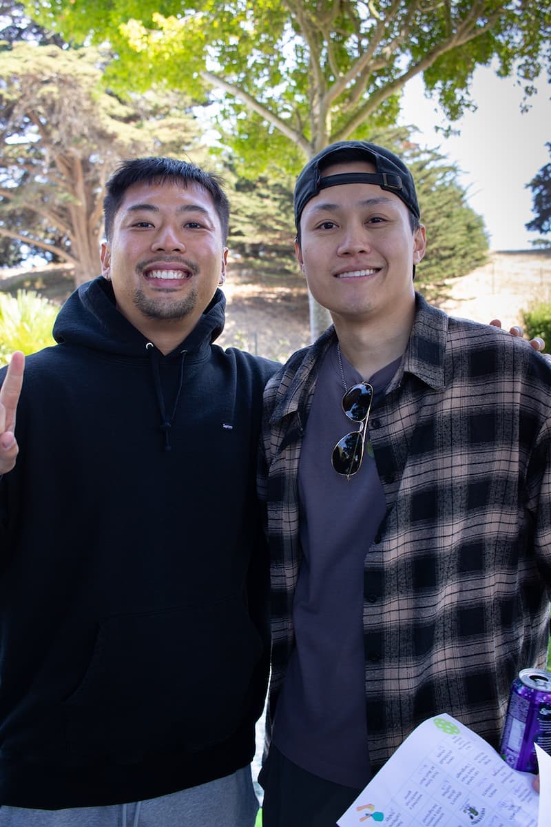 Two members smiling arm in arm at a club hangout